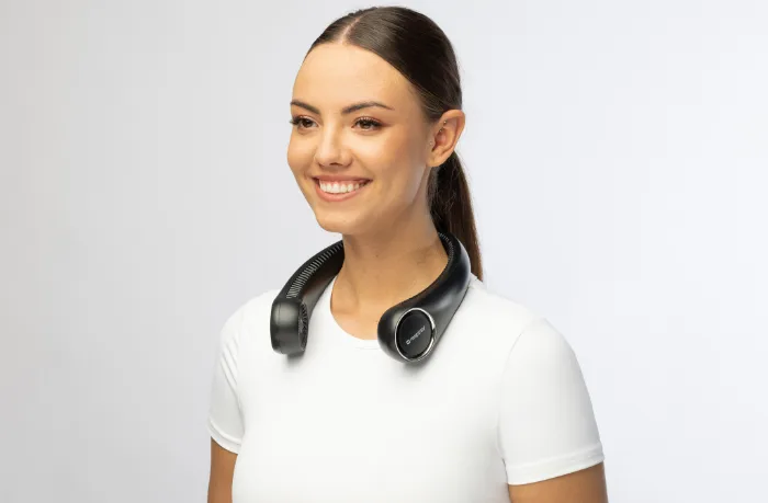 Woman wearing the Respiray Neck Fan for all-day indoor cooling comfort